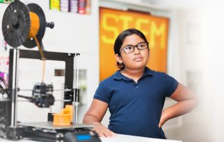 Young girl wearing glasses in a stem class, wondering what exactly is a charter school?