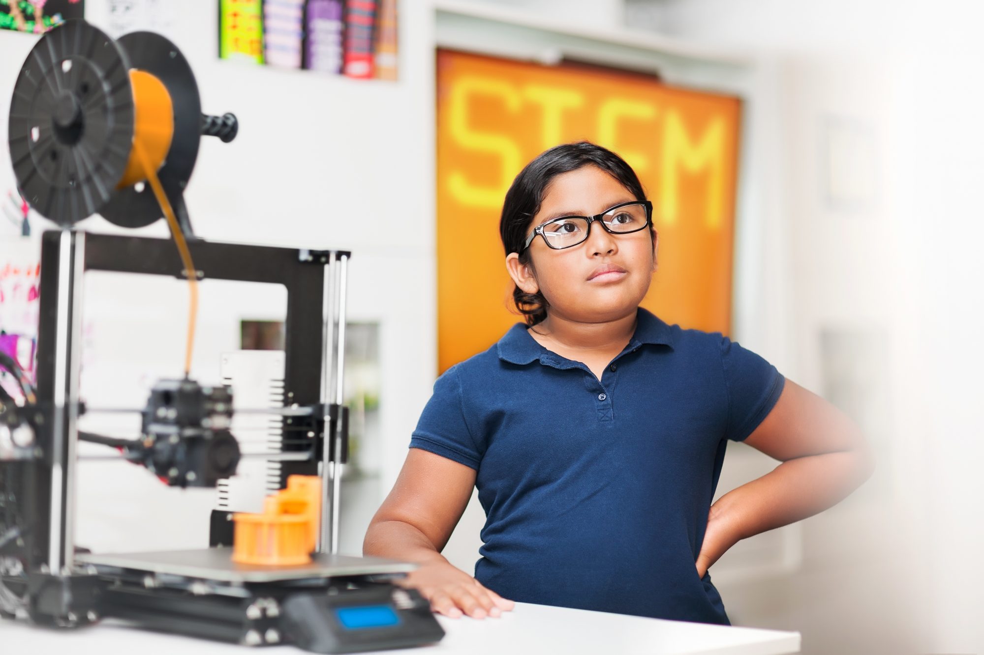 Young girl wearing glasses in a stem class, wondering what exactly is a charter school?