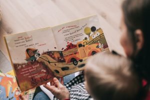parent reading book to child